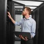 Skillful IT technician establishing connection